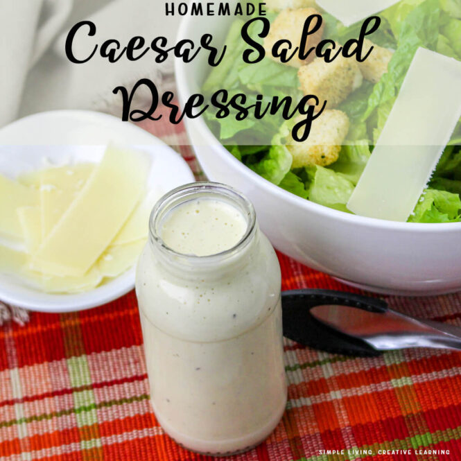 Easy Homemade Caesar Salad Dressing in a jar next to a salad