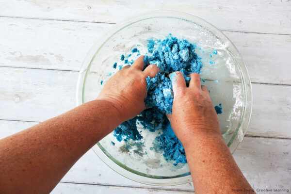 Homemade Kinetic Sand Recipe - mixing with hands