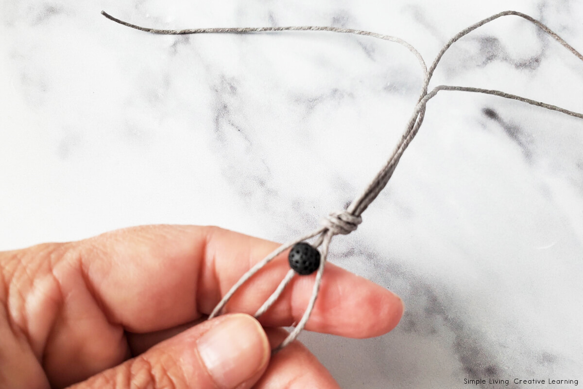 DIY Essential Oil Bead Knot Bracelet tying a knot
