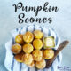 Homemade Pumpkin Scones sitting in a bowl on top of a tea towel with butter and a knife