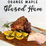 Orange Maple Glazed Ham on a wooden board