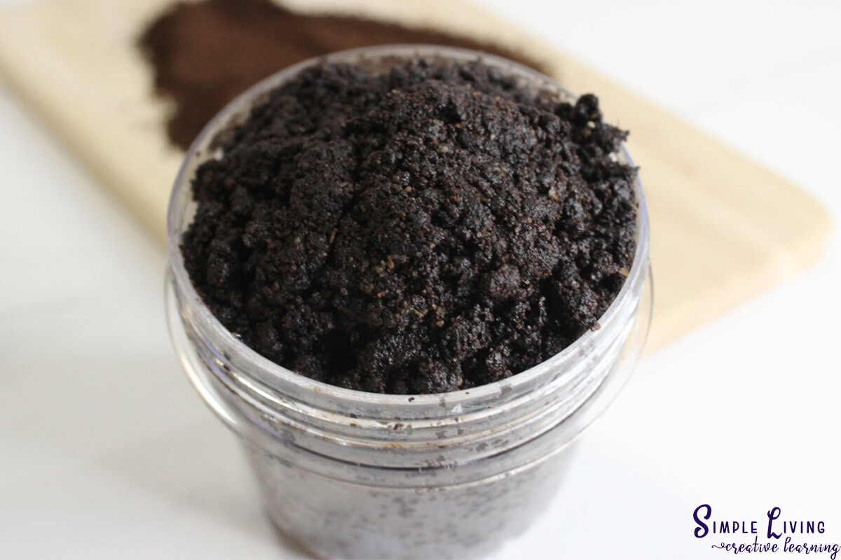 Homemade Coffee Face and Body Scrub with a wooden board behind it