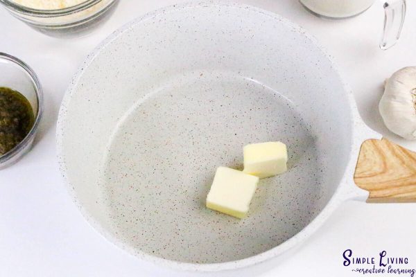 Homemade Alfredo Pesto Sauce adding butter to saucepan