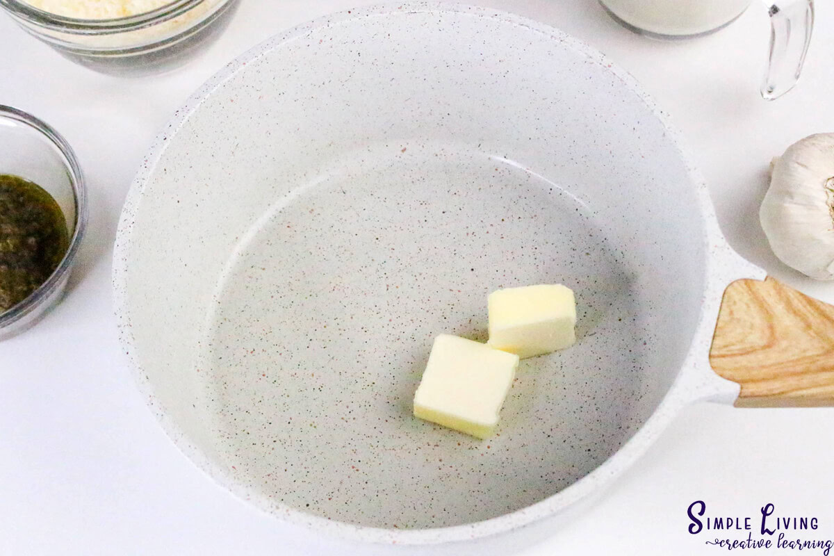 Homemade Alfredo Pesto Sauce adding butter to saucepan