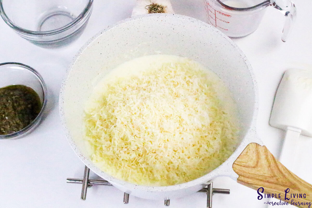 Homemade Alfredo Pesto Sauce adding the parmesan cheese
