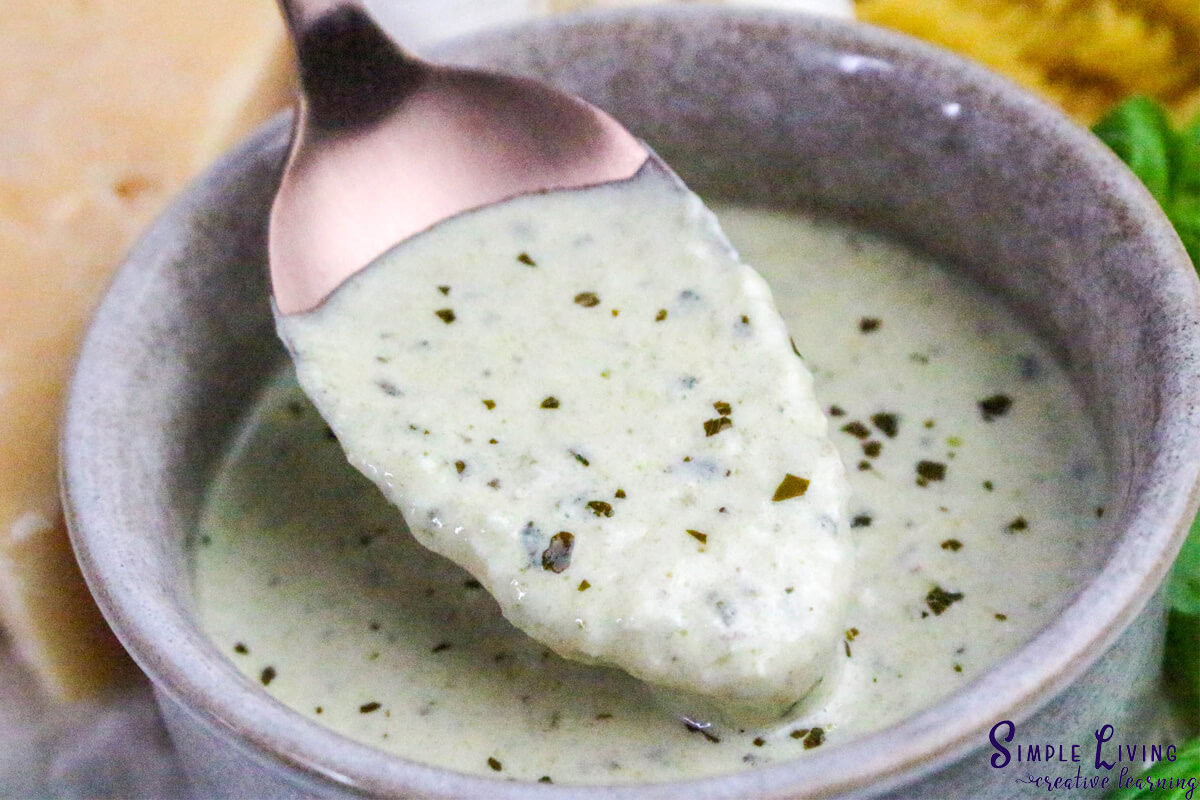 Homemade Alfredo Pesto Sauce picking some up with a spoon