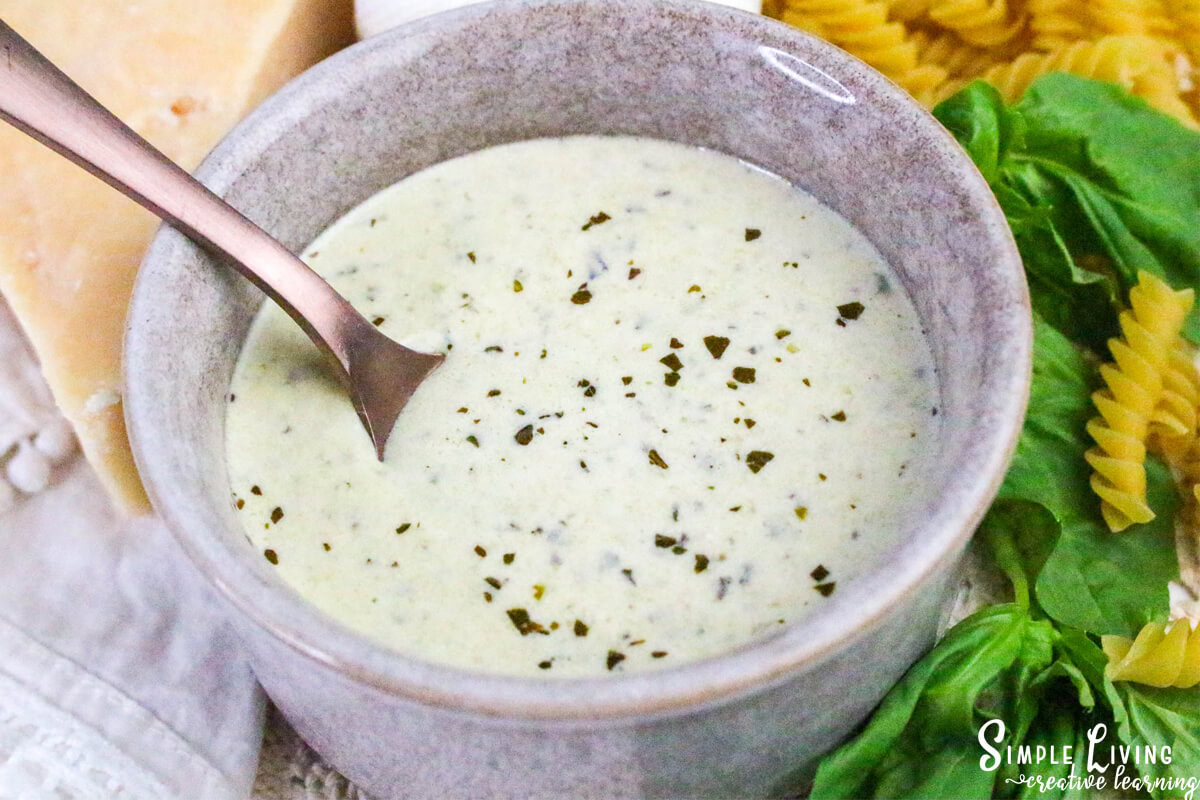 Homemade Alfredo Pesto Sauce in a bowl with a spoon