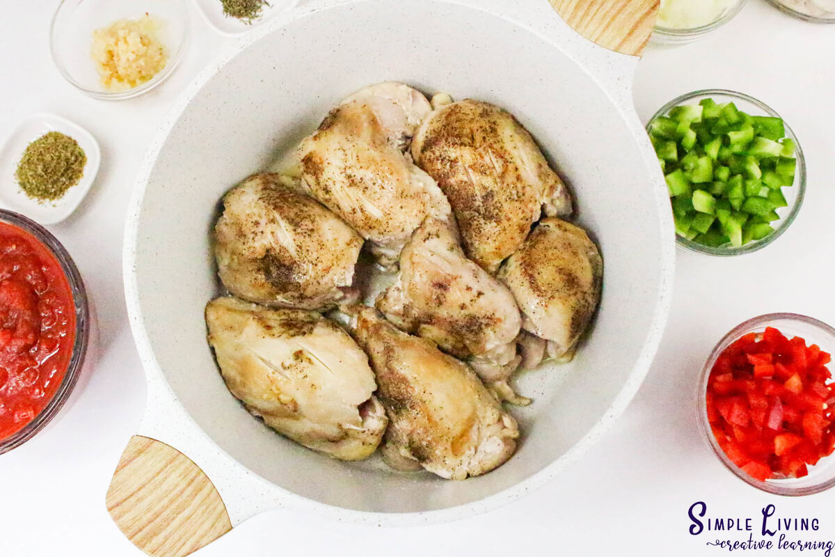 Dutch Oven Chicken Cacciatore seasoning the chicken