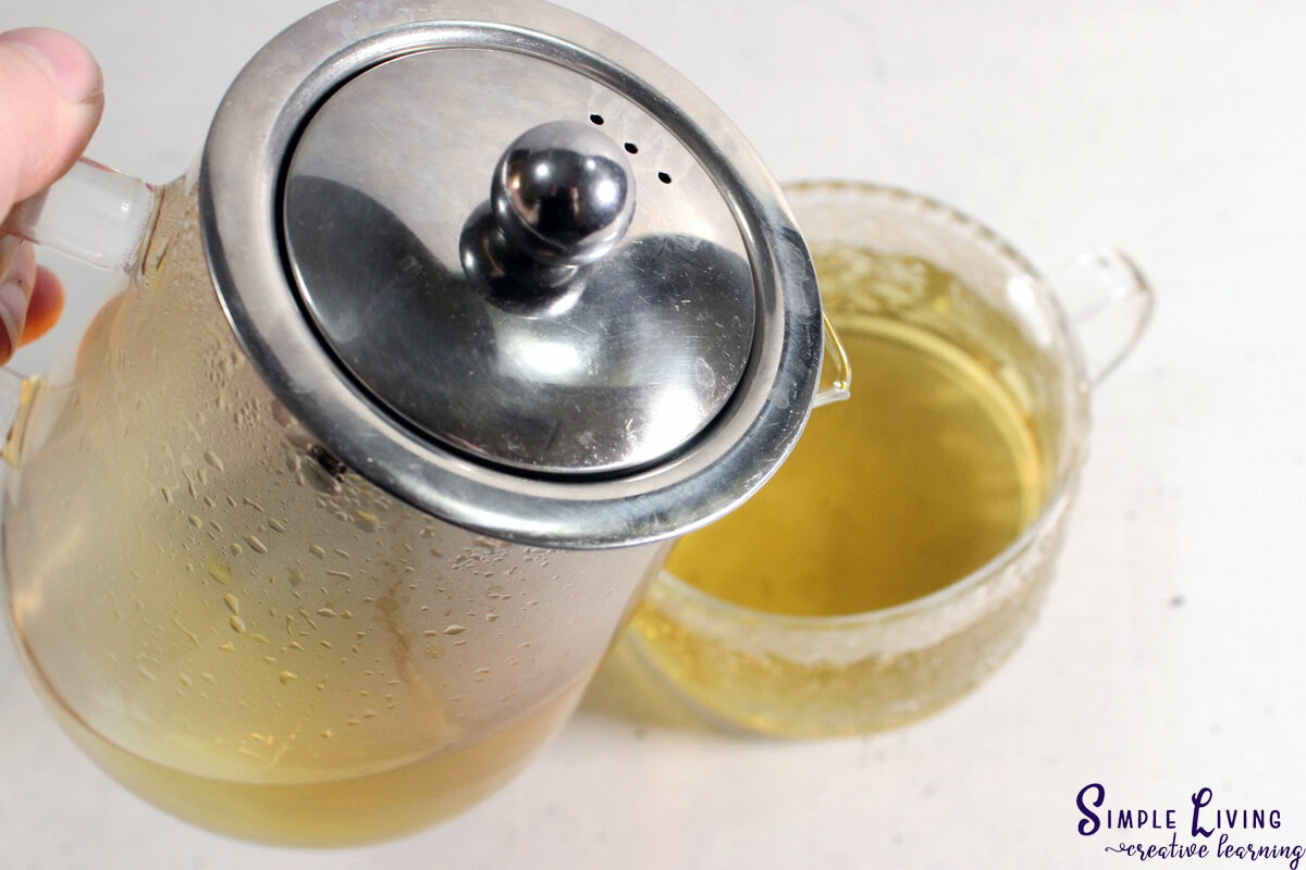 Bee Balm Tea finished steeping pouring into a mug