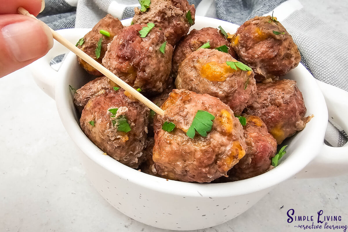 Homemade Carnivore Meatballs in a bowl using a toothpick to get one out