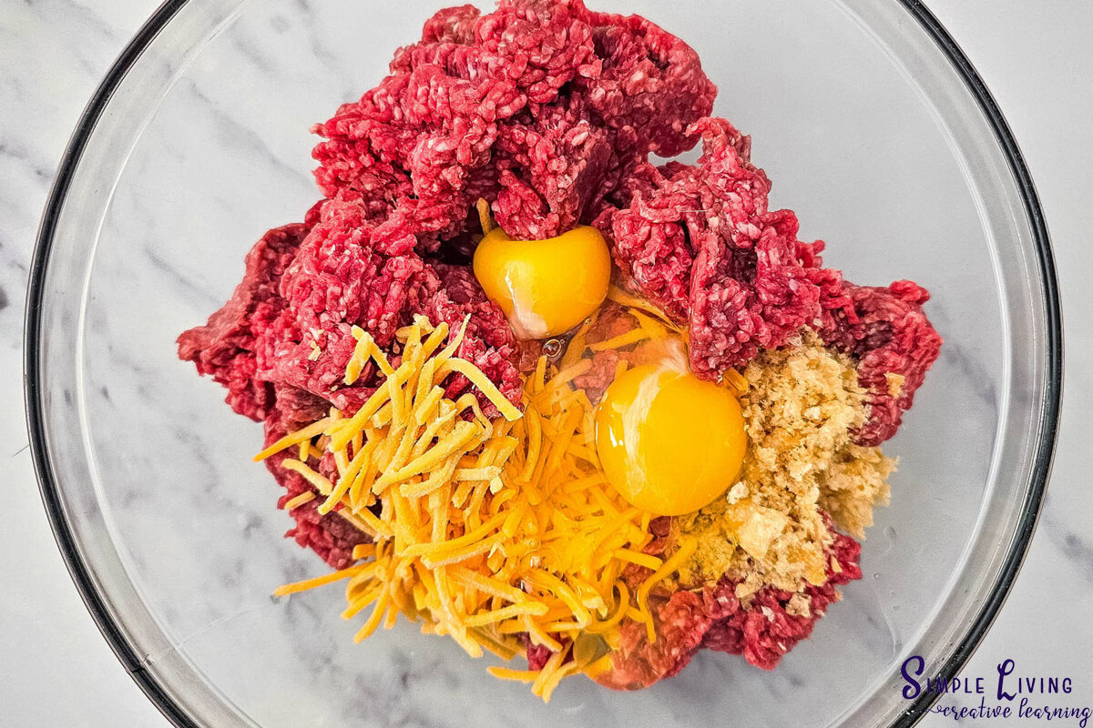 Homemade Carnivore Meatballs add ingredients in a bowl