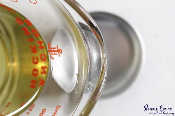 Homemade Dog Paw Balm pouring into tins