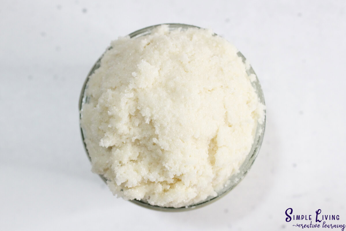 Homemade Tallow Sugar Scrub putting into glass jar