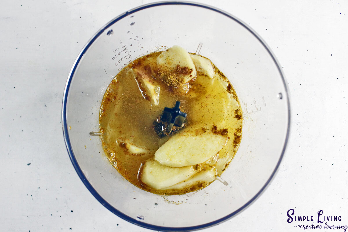 Immunity Shots With Lemon, Ginger and Turmeric adding ingredients to a food processor