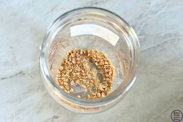How to Rehydrate Dried Sourdough Starter adding dried starter to jar