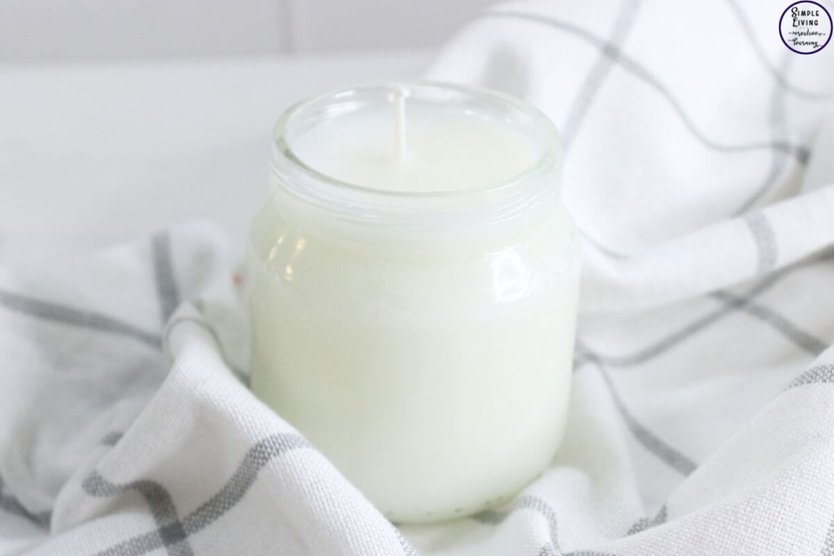 Homemade Tallow Candles in a clear glass jar ready to use
