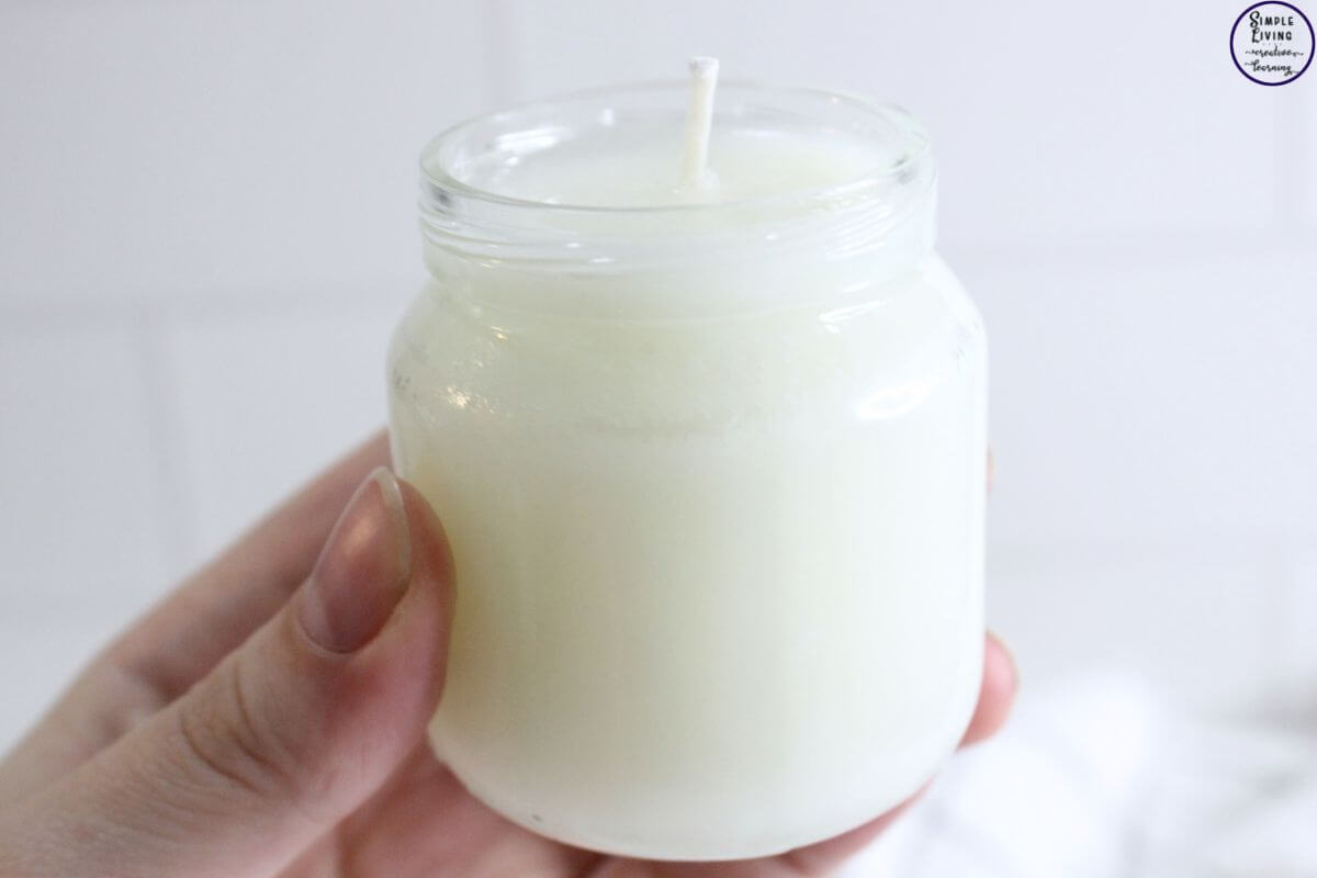 Homemade Tallow Candles hand holding jar