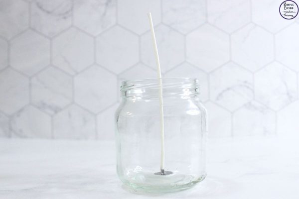 Homemade Tallow Candles placing the wick into the jars