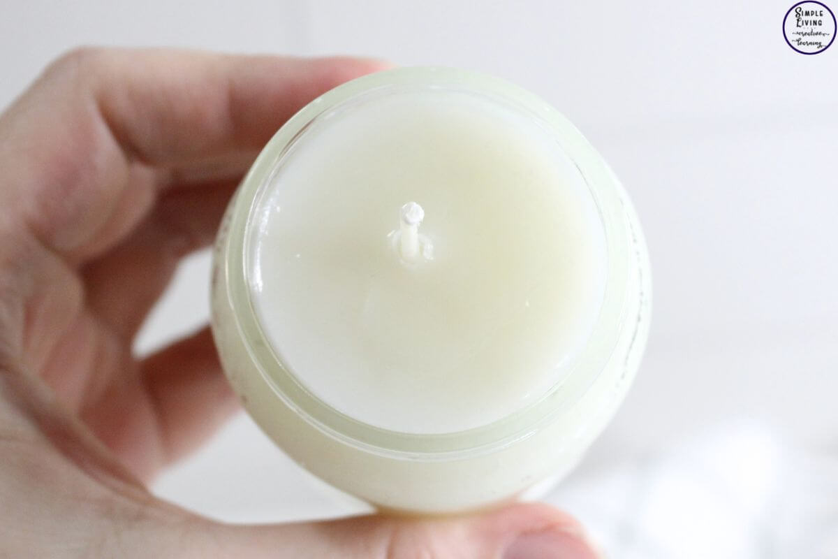 Homemade Tallow Candles looking on jar being held by hand