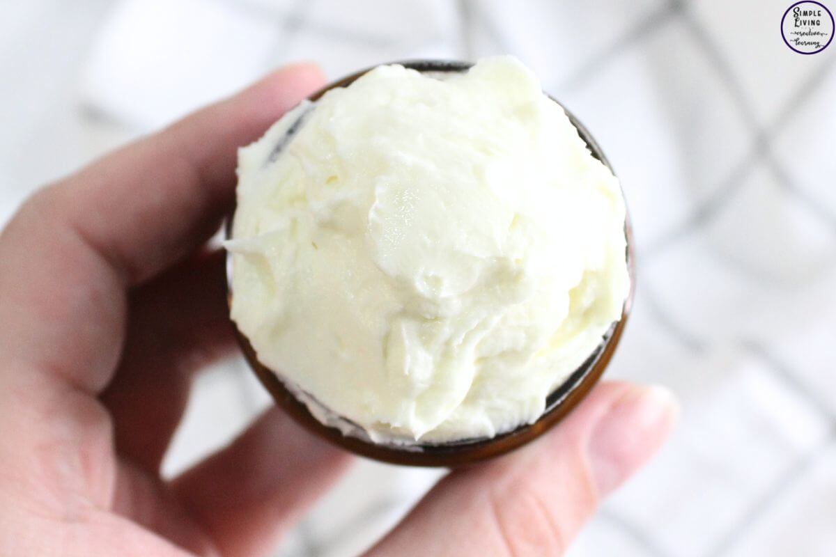 Homemade Tallow Lotion hand holding jar ready to use