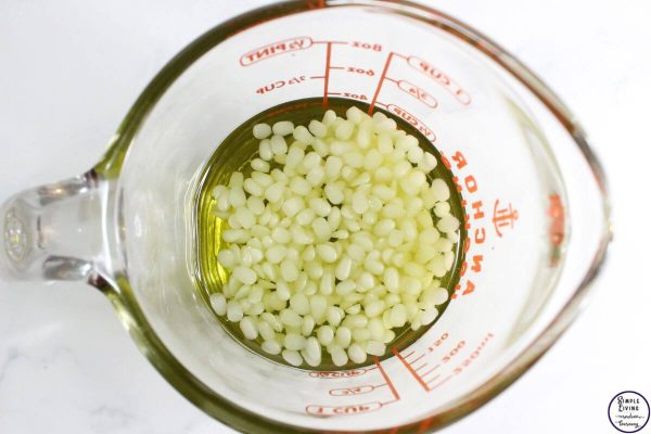 Homemade Oregano Salve melting the beeswax and infused oil together