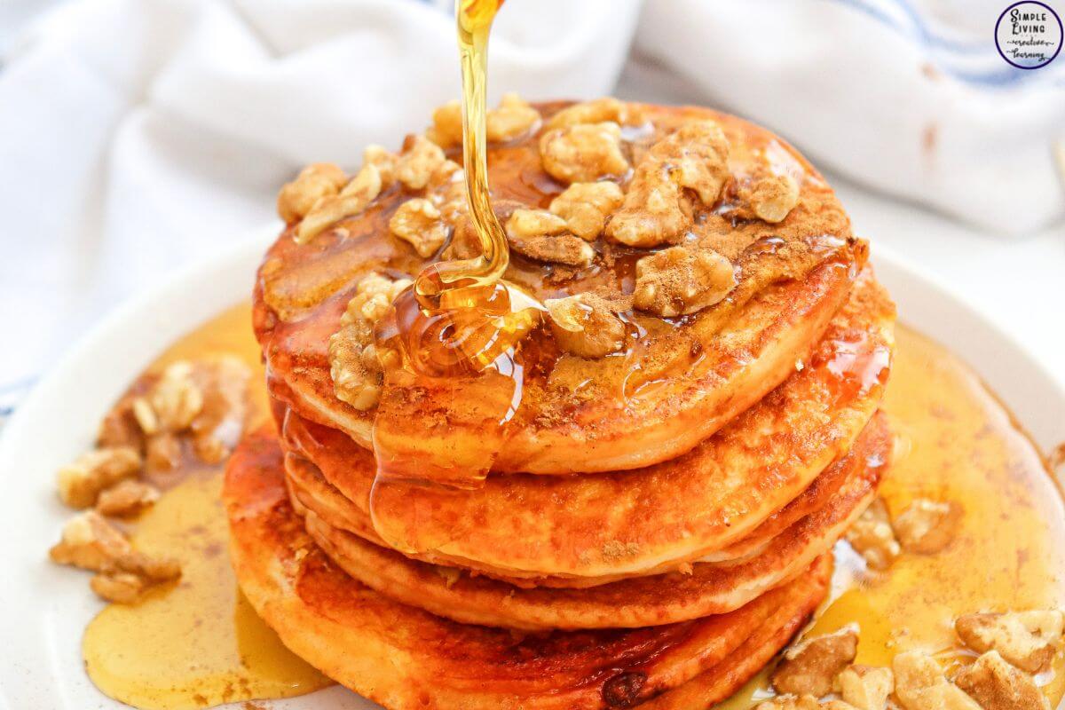 Pumpkin Pancakes with syrup being drizzled on them