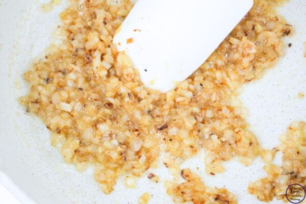 Chicken Macaroni and Cheese sautéing the onion and garlic
