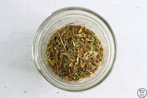St. John's Wort Salve adding dried flowers and leaves to jar