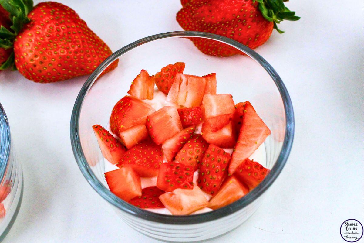 Strawberry Yoghurt Parfaits adding a layer of strawberries