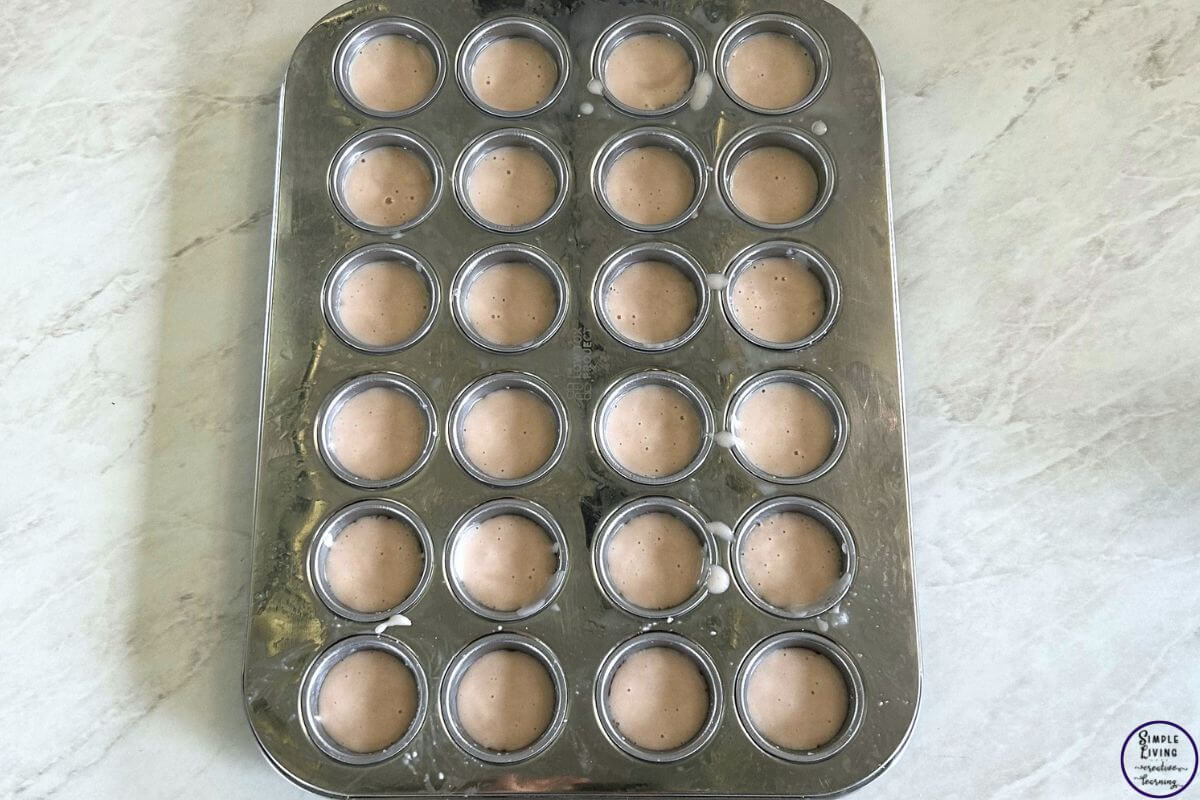 2 Ingredient Cupcakes spooning mixture into mini cupcake baking tray