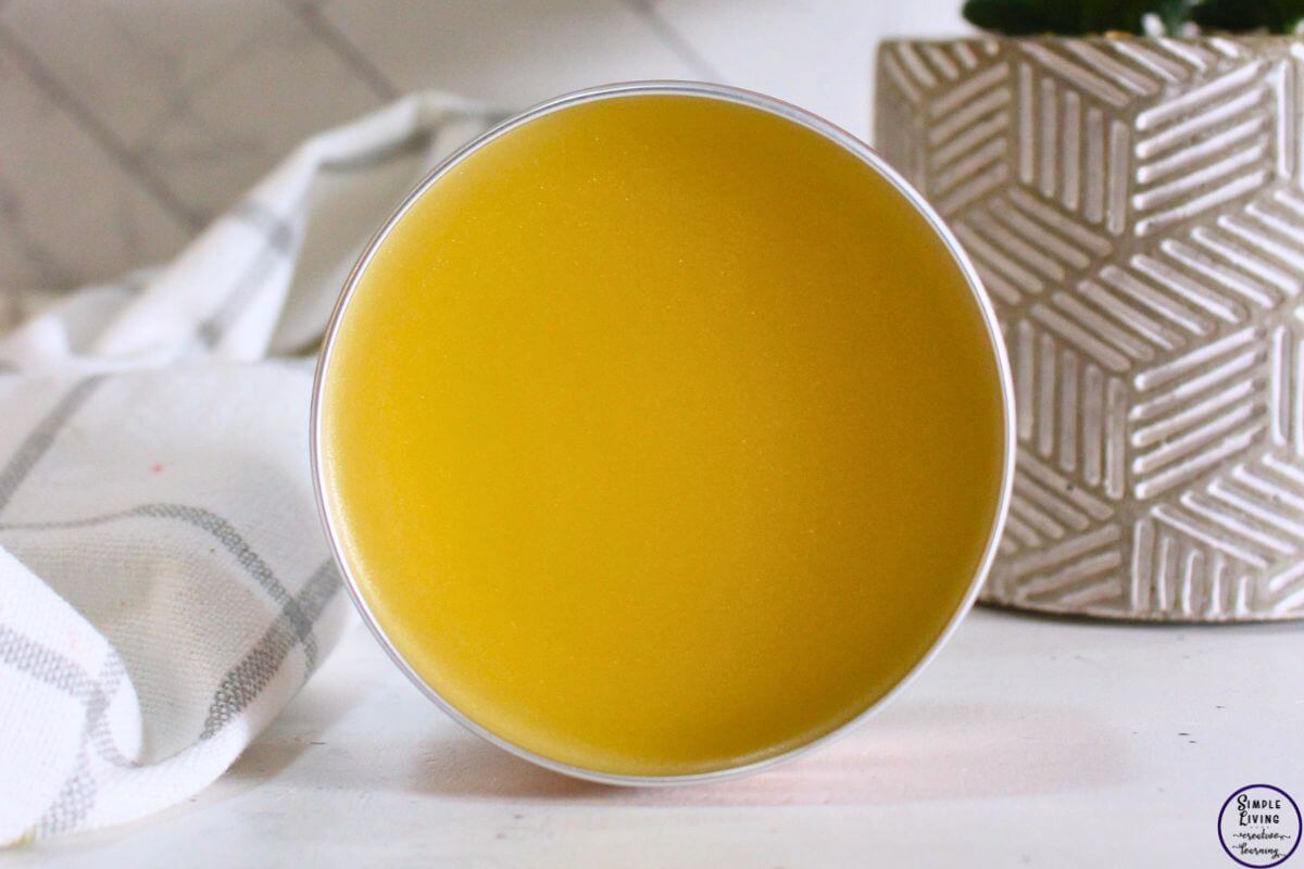 Homemade Frankincense Salve in a tin that is standing on its side