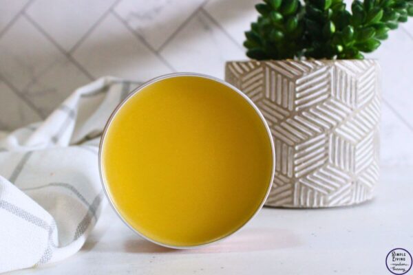 Homemade Frankincense Salve in a tin standing on its side