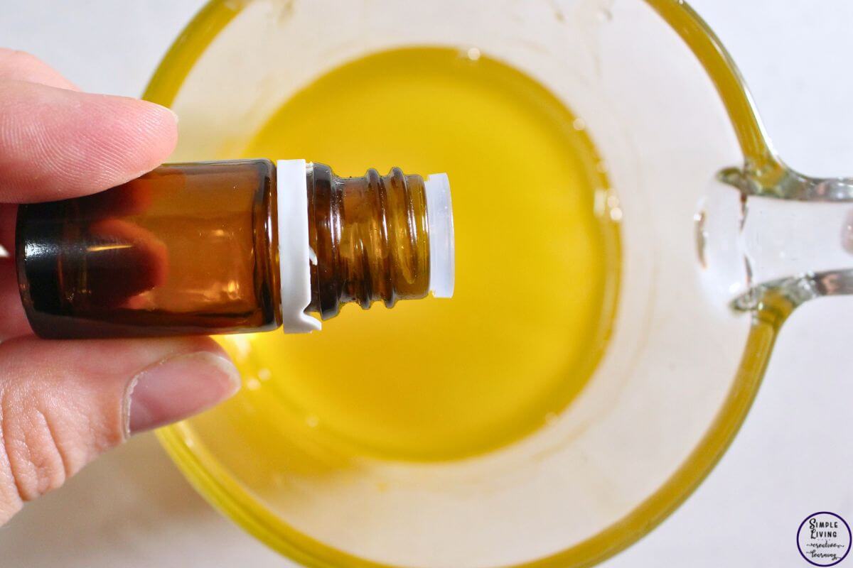 Homemade Frankincense Salve adding essential oils