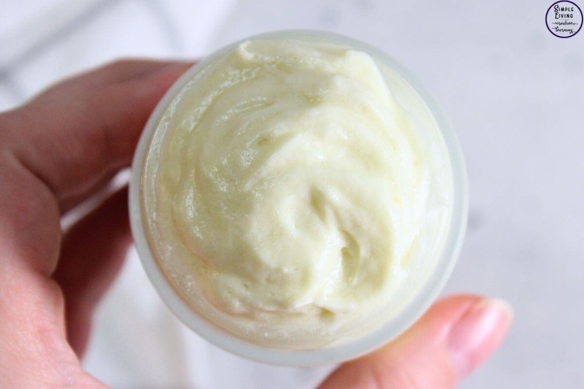 Homemade Leave in Conditioner in a glass jar being held with a hand