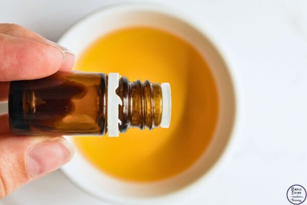 Homemade Tick Spray adding essential oils to apple cider vinegar