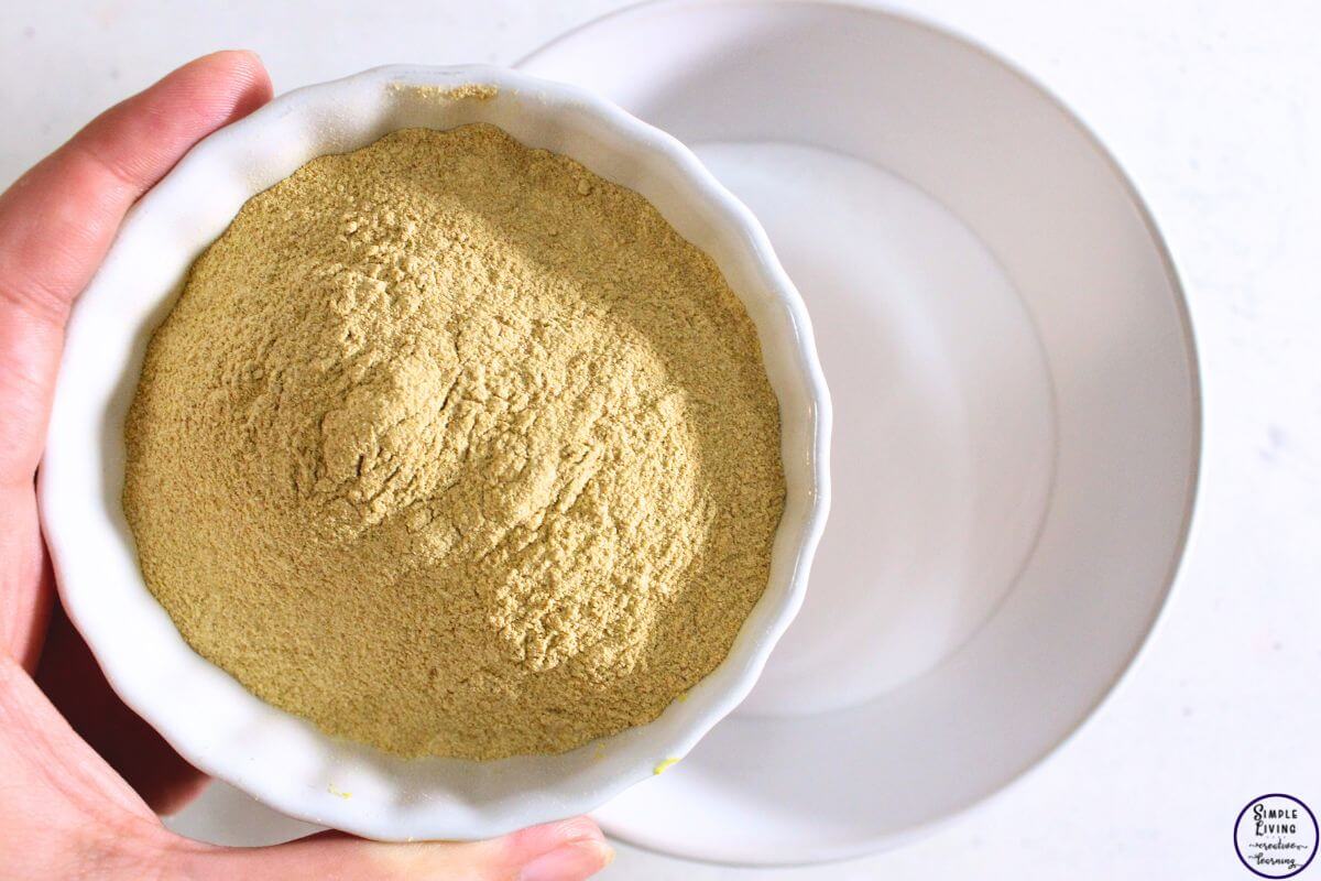 Homemade Lemon Sink Cleaner adding lemon powder to bicarbonate of soda