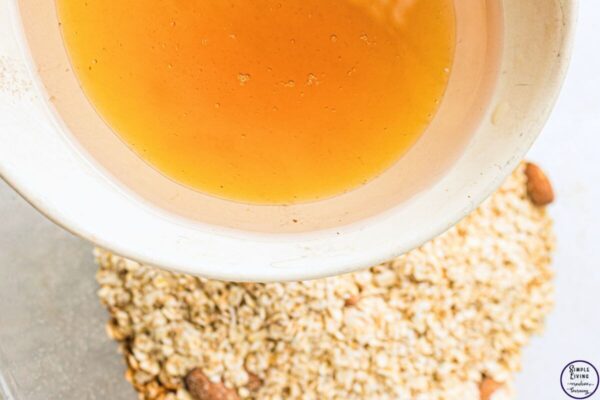 Homemade Granola Recipe mixing wet and dry ingredients