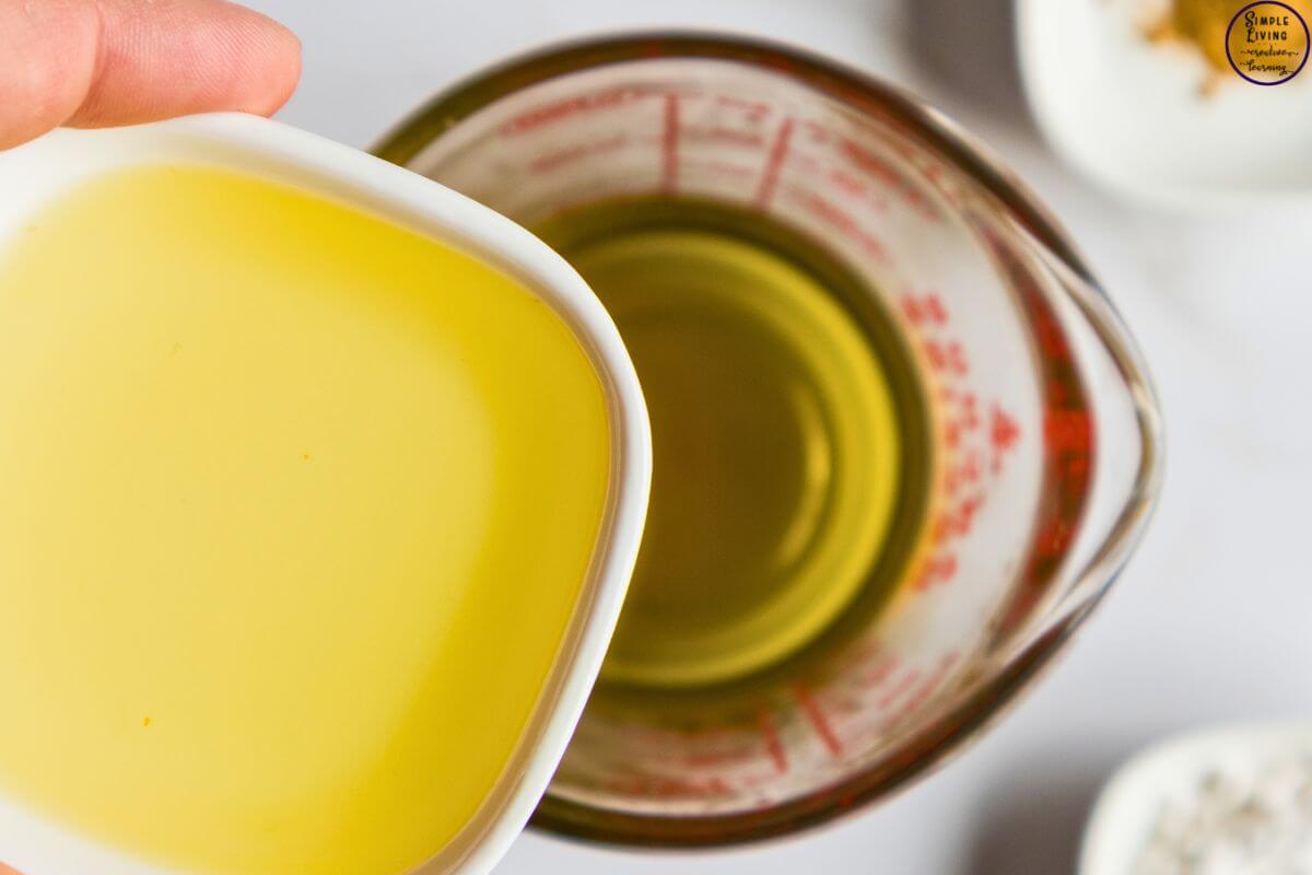 Homemade Tallow Deodorant Stick adding carrier oil to beeswax mixture