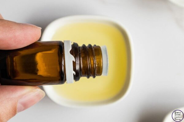 Homemade Tallow Deodorant Stick adding essential oils to carrier oil.