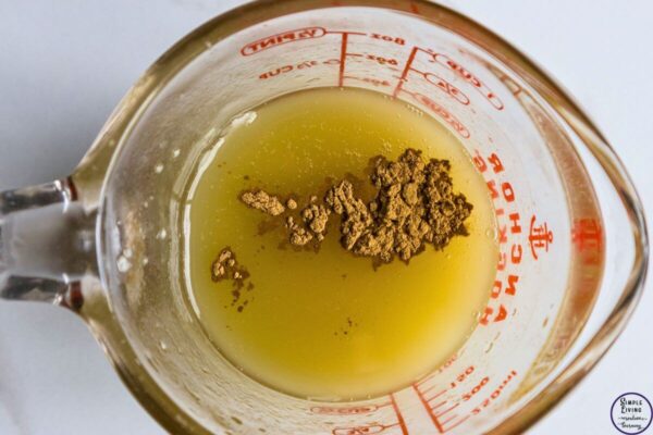 Homemade Tallow Deodorant Stick adding arrowroot powder and bentonite clay