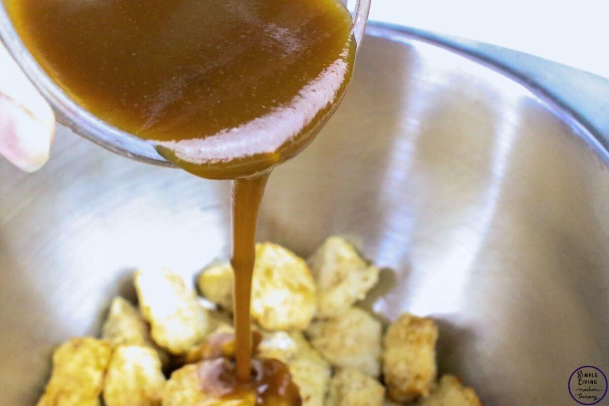 Orange Chicken Recipe coating the chicken in the sauce