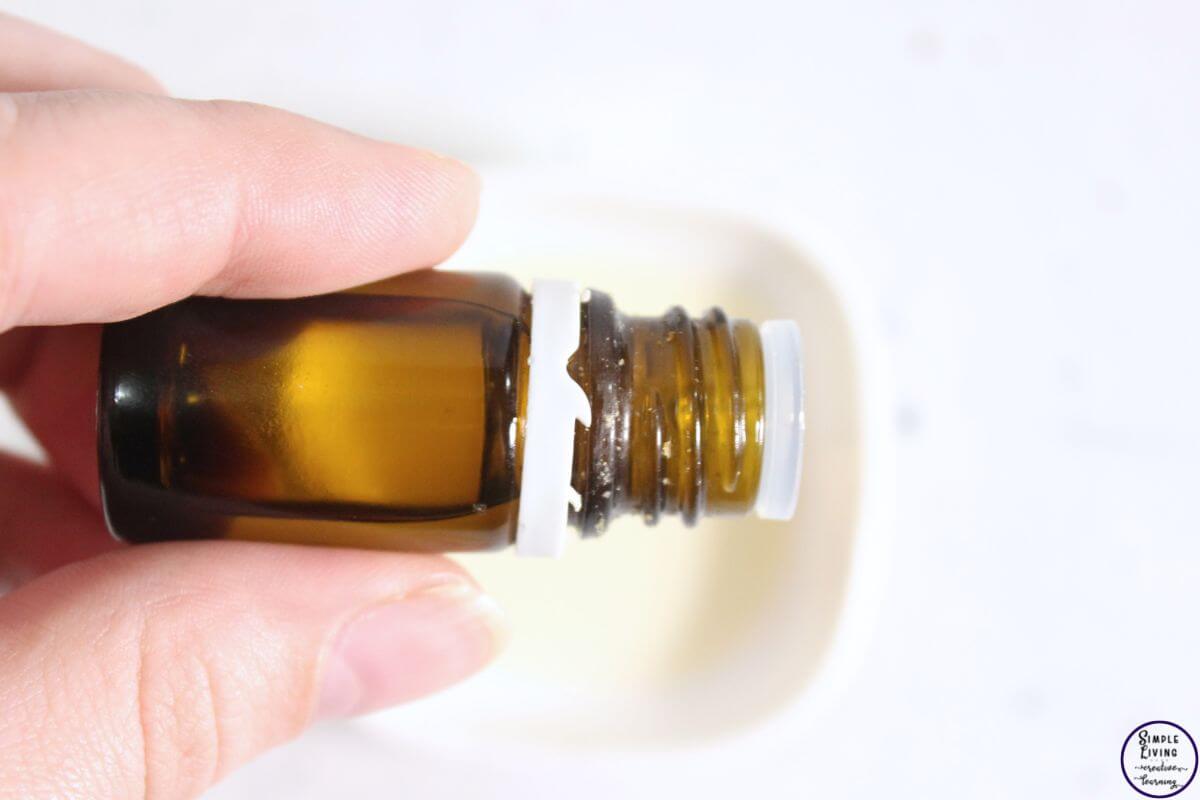 homemade degreaser spray adding essential oils to Castile soap
