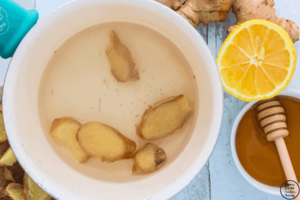 ginger tea adding ginger to water in saucepan