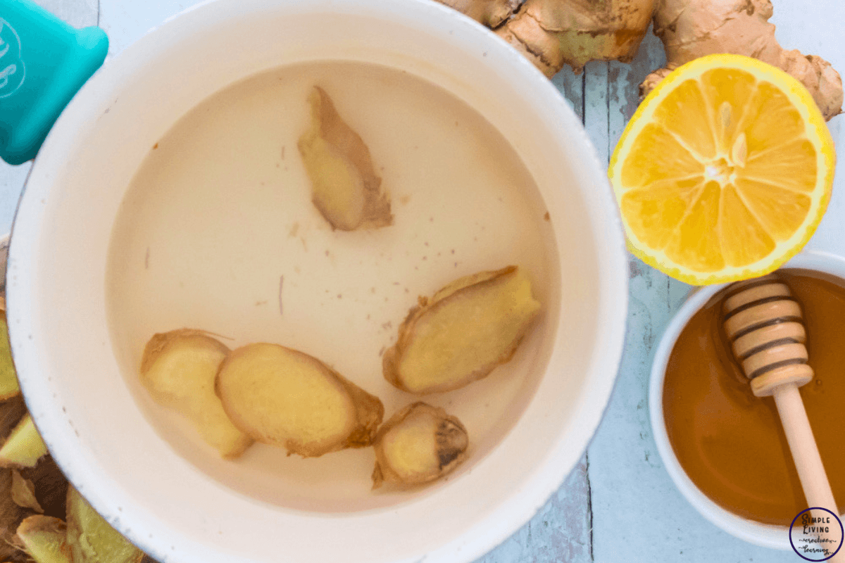 ginger tea adding ginger to water in saucepan