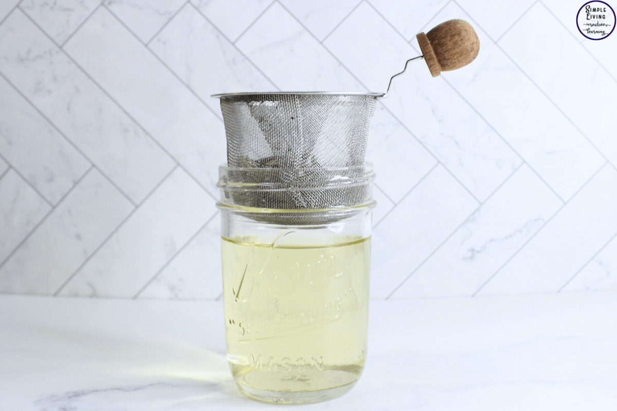 Rosemary Spray for Hair straining the rosemary water