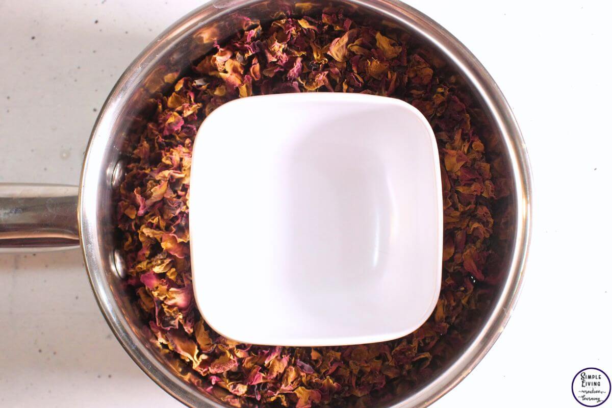 Homemade Rose Hydrosol roses in pot with bowl on top